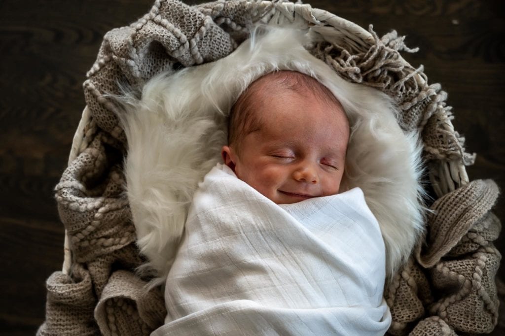 Denver Lifestyle Photographer takes a photograph of a newborn baby. 