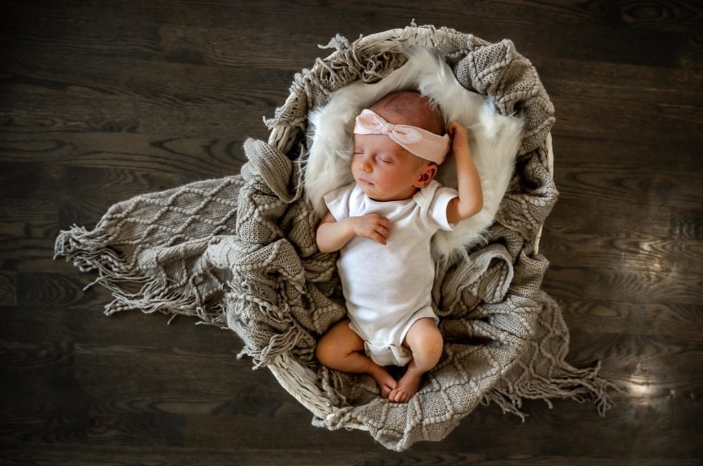 Denver Lifestyle Photographer takes a photograph of a newborn baby. 